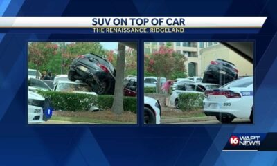 SUV crashes on top of another car