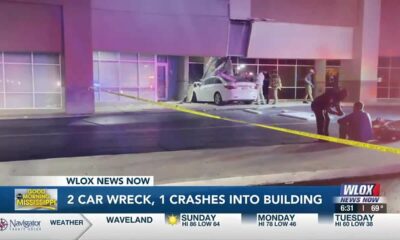 Two car wreck in Biloxi, one crashes into building