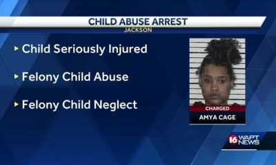 Woman charged after 1-year-old seriously injured