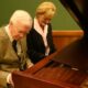 Touching moment: Cochran plays piano with successor