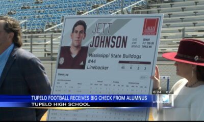 Jett Johnson's NIL partnership gives back check to Tupelo football program