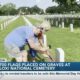 Volunteers place flags on gravesites at Biloxi National Cemetery