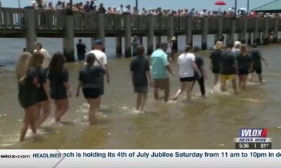 Local church holds public baptism on the beach in Ocean Springs