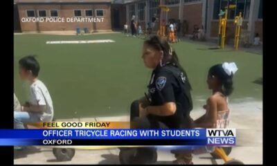 Oxford Police officer rides tricycle with kids