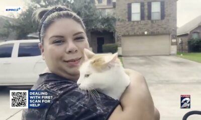 Family reunites with cat after evacuating home during Deer Park pipeline fire.