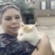 Family reunites with cat after evacuating home during Deer Park pipeline fire.