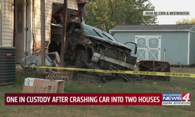 One in custody after crashing car into two houses