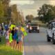 Community lines up with signs to thank parade of lineworkers