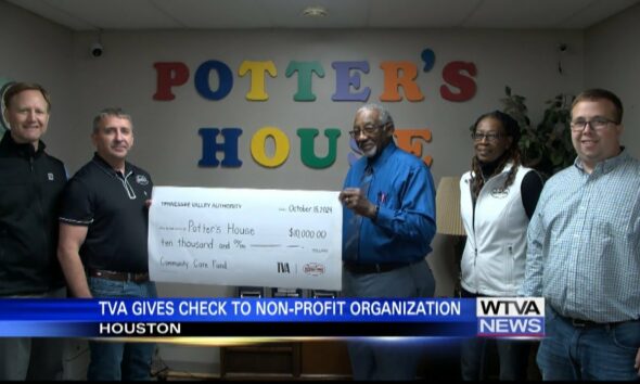 Natchez Trace Electric and TVA present check to non-profit organization in Houston