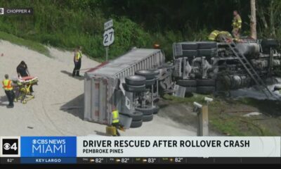 Driver rescued after semi truck rolls over in Pembroke Pines