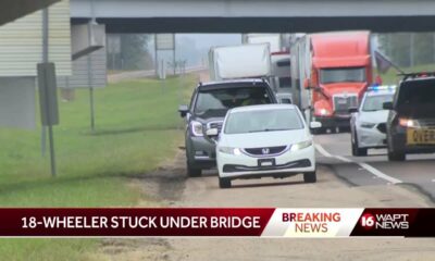 Truck gets stuck under an overpass