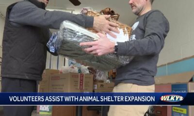 Volunteers help Animal Care Society, a no-kill shelter, prepare expanded facilities