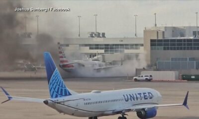 12 hurt after American Airlines plane catches fire at Denver airport